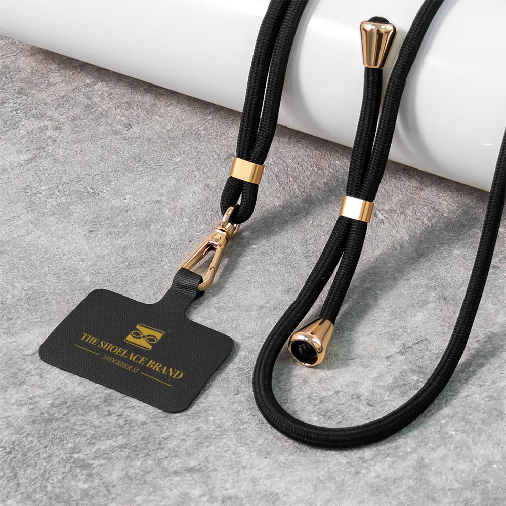 Universalt mobilband i svart och guld