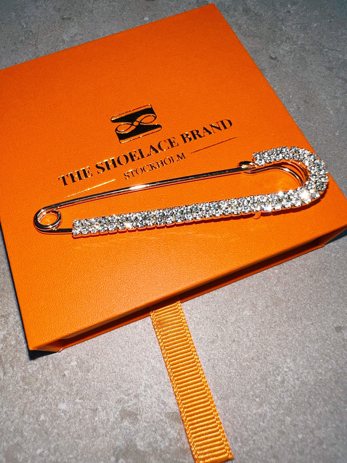 Crystal Fashion Safety Pin Gold The Shoelace Brand close up on box