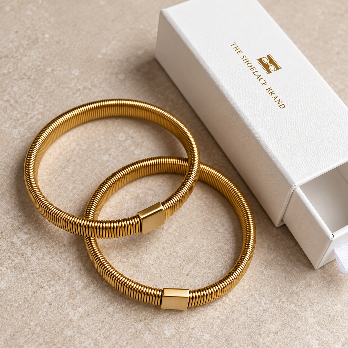 Shirt Sleeve Holder Gold The Shoelace Brand on table