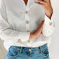 Signe White Crystal Gold Button Charm on a white shirt and as cuffs